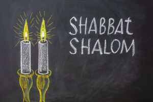 Jewish,Greetings,Shabbat,Shalom,And,Candles,Painted,On,A,Chalkboard.